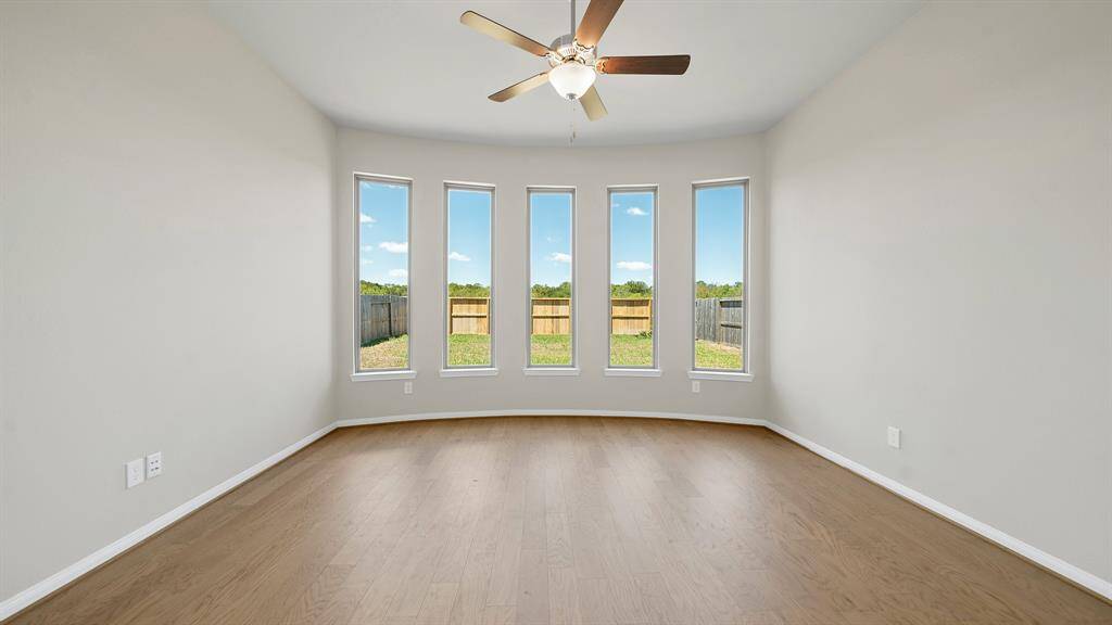Welcome to the Prestigious Primary Suite, featuring handsome hardwood flooring, ceiling fan and BAY WINDOWS overlooking the Beautiful Backyard.