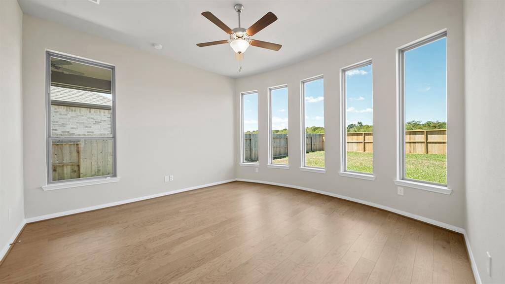 This Spacious Primary Bedroom offers plenty of space for a seating area, high ceilings and overlooks the Beautiful Backyard.