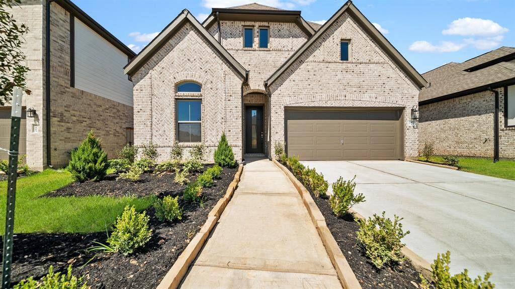 Upon arrival to this beautiful home the Beautiful Brick Elevation greets you as well as the luscious landscaping and stone edge walkway.