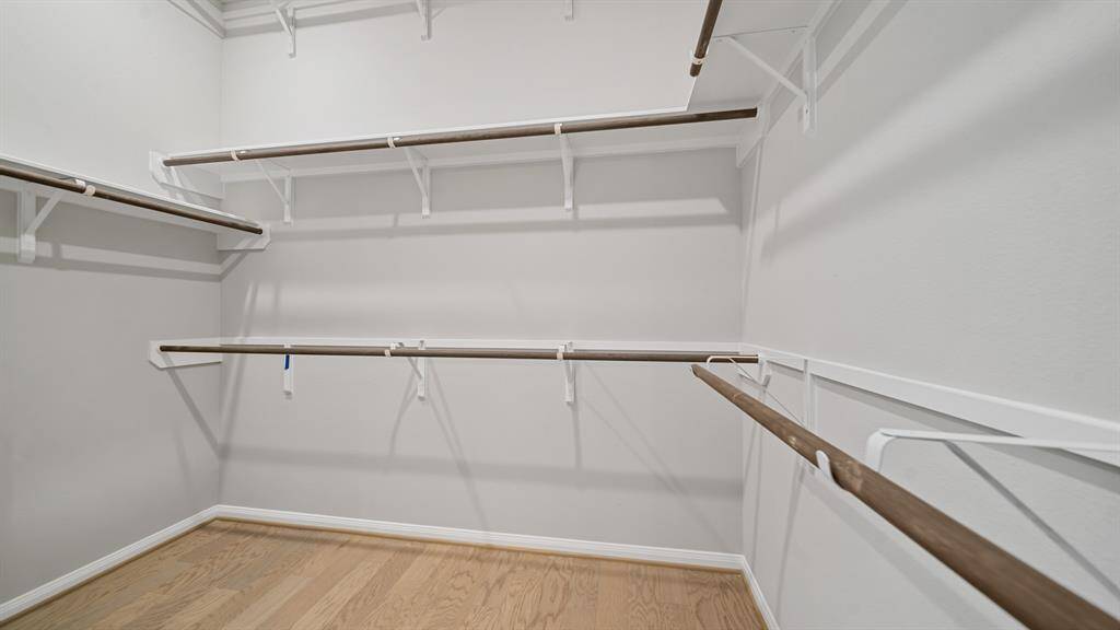 A look into the Spacious Walk In Closet that provides plenty of shelf spaces for holding your entire wardrobe!