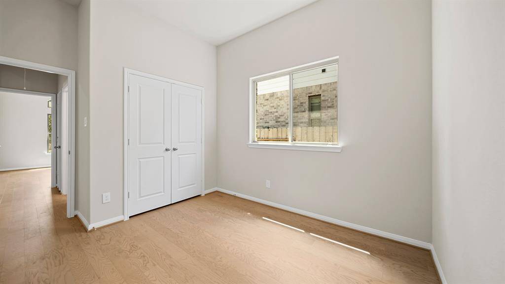 Spacious Secondary Bedroom with gorgeous flooring, natural lighting, and enough space to make it your own!