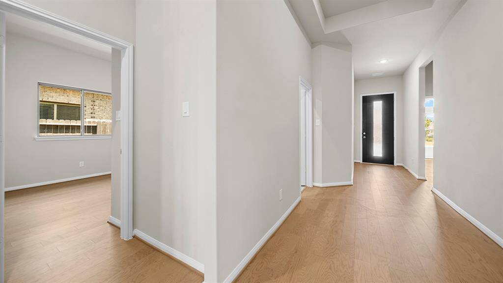 Upon entry into the Foyer, greeted by a custom front door, handsome hardwood flooring and tray ceiling as you enter into the living spaces.