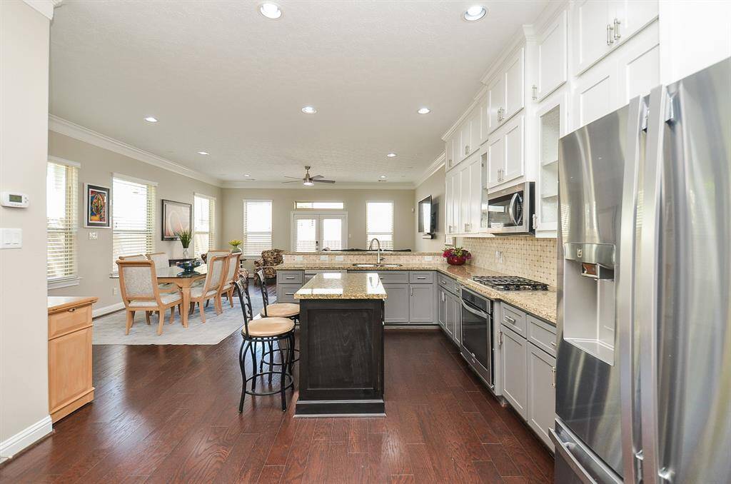Open, airy, and made for connection. The kitchen flows seamlessly into the dining and living areas, so whether you're cooking, chatting, or helping with homework, you're always part of the moment. There's space to move, space to gather, and space to just be—which is exactly what home should feel like.