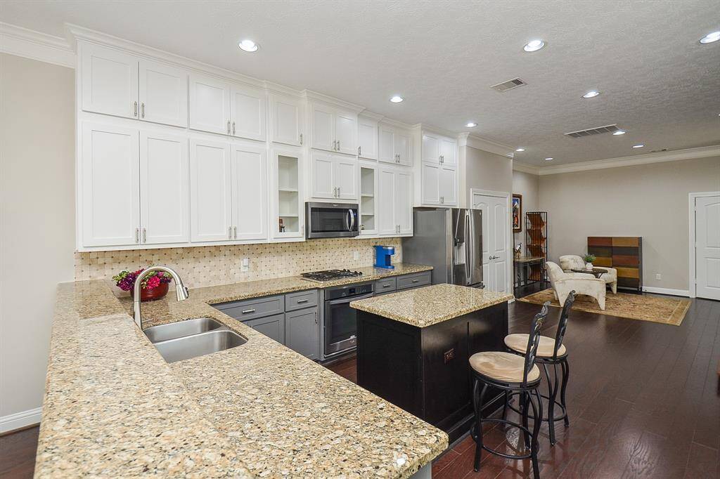 More space, less stress. These sleek granite countertops offer plenty of room to prep, chop, and plate—especially with that open stretch right beside the sink. It's the kind of setup that makes cooking feel smooth, not scattered.