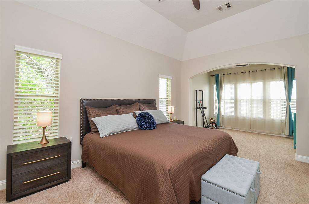 Your calm, sunny retreat. With 11' pop-up ceilings, fresh paint, a new ceiling fan, and beautiful natural light, this primary bedroom feels open, airy, and perfectly private. It’s a space that says exhale—you’re home.