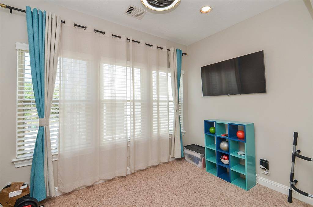 Light-filled and made to flex. This cozy sitting area off the primary bedroom is perfect as a home office, nursery, wellness space, or even a private workout zone. The modern fandelier adds just the right touch of style—whatever you use it for.