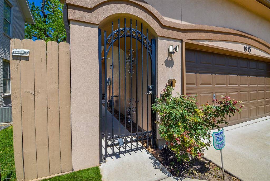 A private path to your front door. This wrought iron entry gate, freshly painted and full of charm, offers a secure, welcoming feel—perfect for greeting guests, keeping small pets safe, or just adding that extra layer of peace of mind.