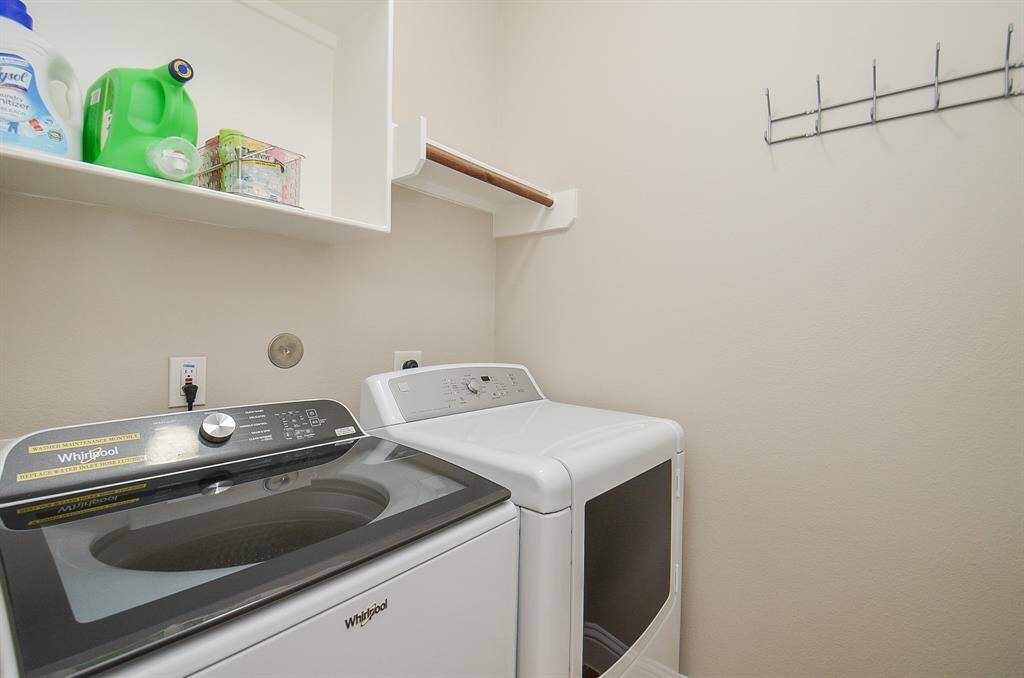 Laundry day just got easier. With a modern washer and dryer that stay, plus custom Elfa shelving and a handy drying rack, this bright space makes washing, folding—even sorting socks—feel a little more doable.