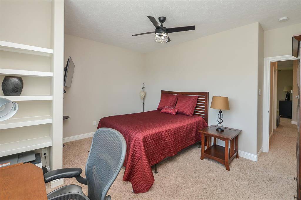 Sunshine, storage, and serious charm. This bright  third-bedroom features built-in shelving, a walk-in closet, and a big window that fills the space with natural light—perfect for creativity, quiet time, or a room that truly feels like home.