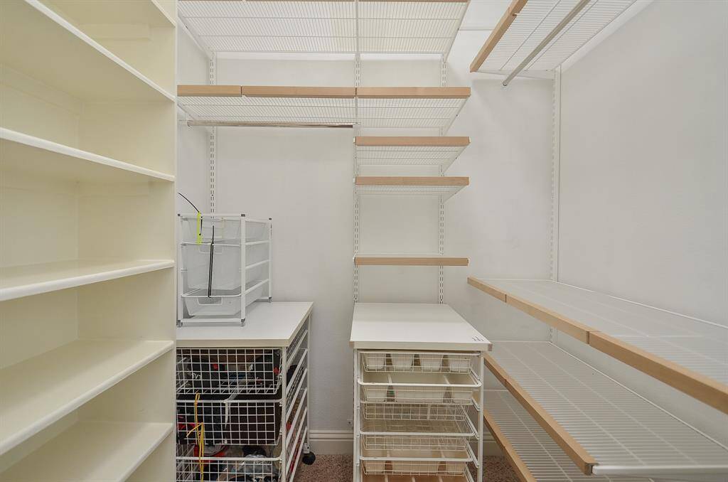 A closet that actually keeps up. Outfitted with a custom Elfa system (2023), this walk-in gives you smart storage, flexible shelving, and space for everything—without the clutter.