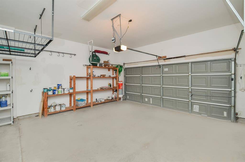 Room for cars, gear, and everything in between. This spacious two-car garage comes with built-in shelving and overhead storage, making it easy to keep things organized—whether it’s tools, bikes, or holiday bins waiting their turn.