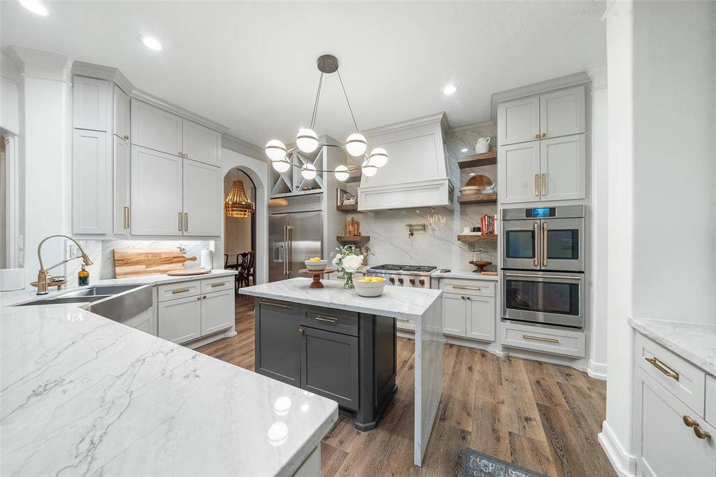 Your dream kitchen! Quartzite counters with waterfall, custom lighting, new hardware, custom cabinets with soft close, 48" fridge, Cafe Appliances, Vigo Oxford 36" Farmhouse double basin sink, Brizo pull down faucet, Brizo pot filler.