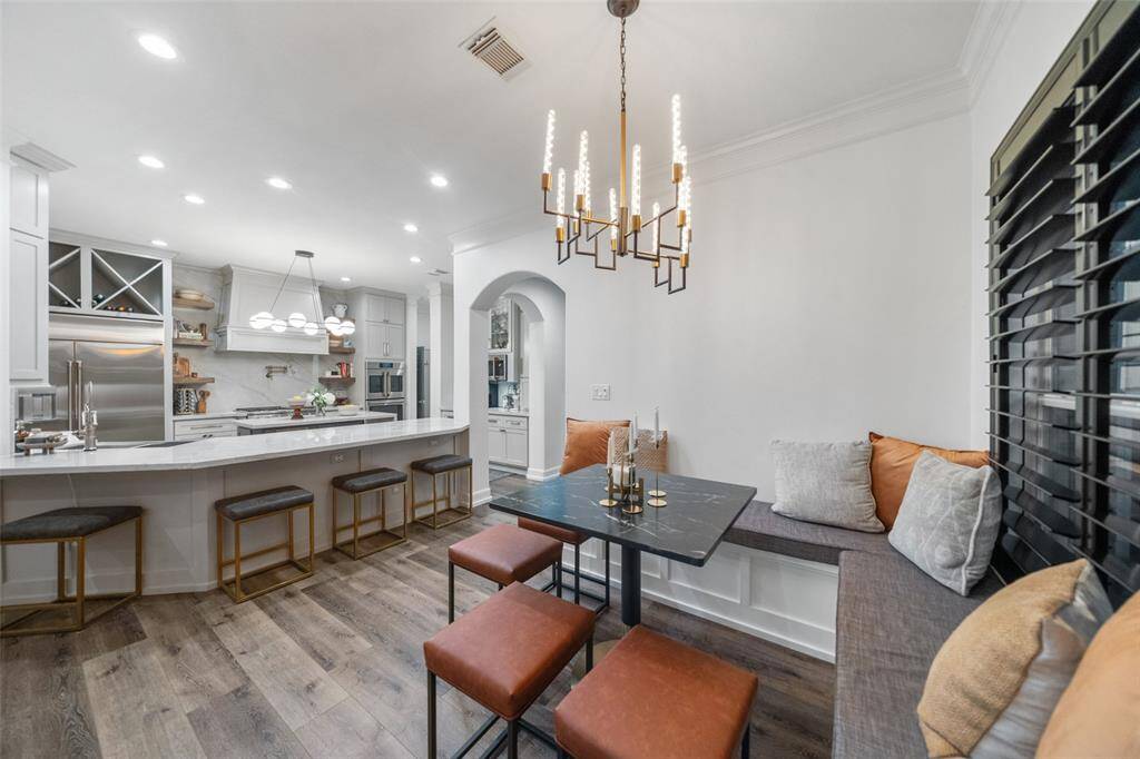 Breakfast area with custom lighting and built-in seating with storage.