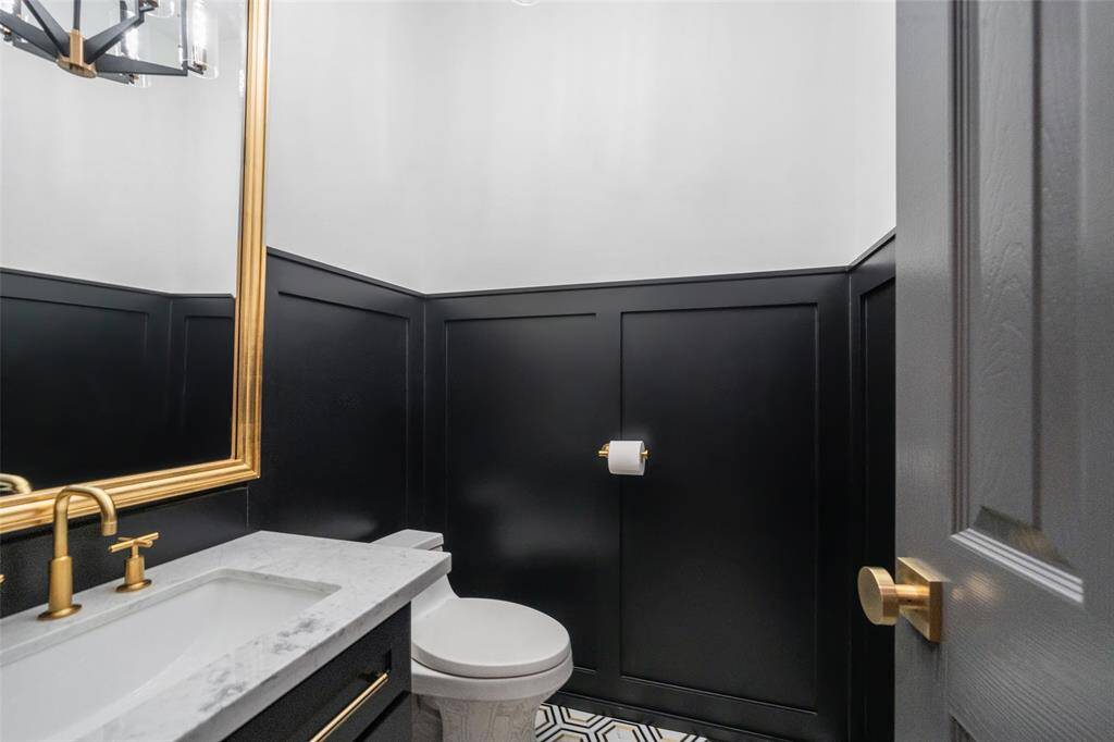 Guest bathroom with Carrara marble countertop, new fixtures and new toilet.