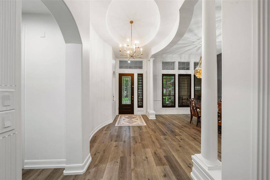 Entry into the home is welcoming with custom lighting fixtures throughout.