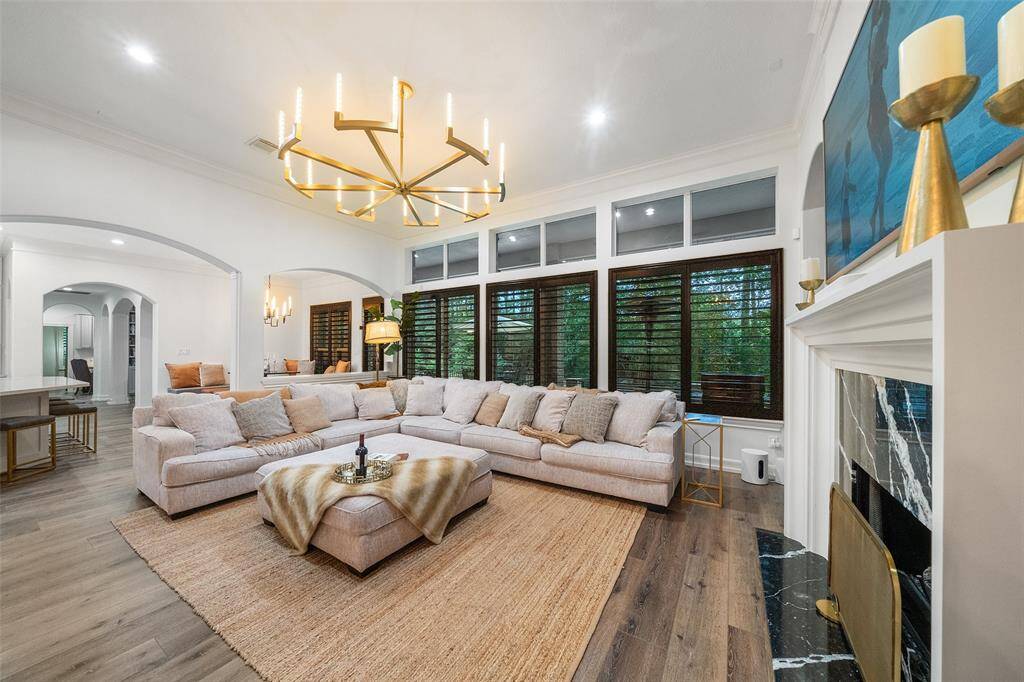 The living area is spacious and has a wall of windows overlooking the backyard. Custom 5" Shutters throughout.