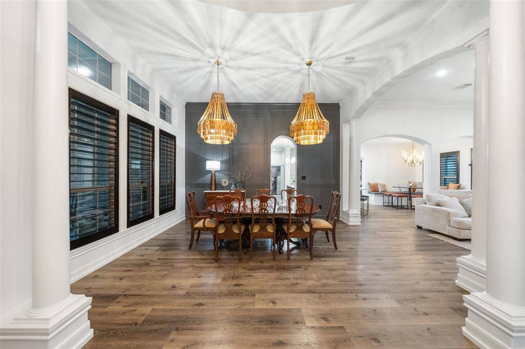 Formal dining area with custom lighting and luxurious SPC Flooring for durability.