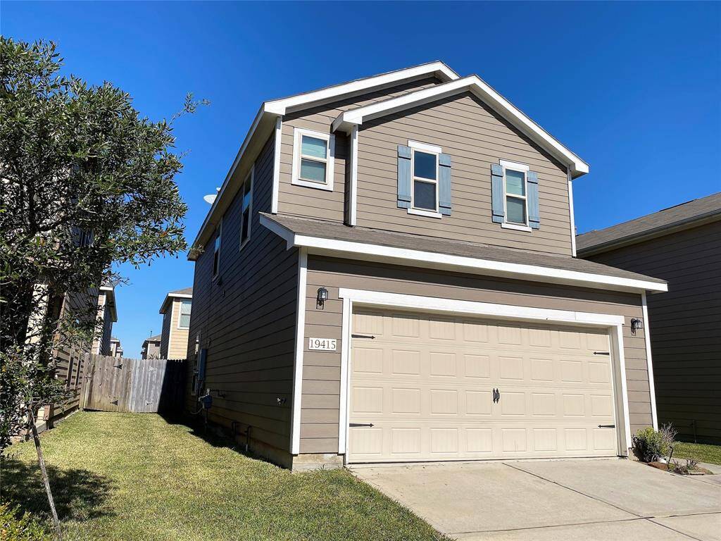 Modern kitchen with sleek dark cabinetry, stainless steel appliances, and ample natural light from large windows. Perfect for cooking and entertaining.