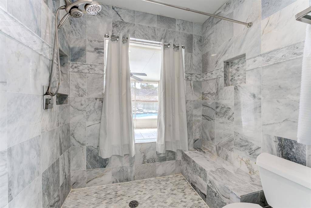 Enjoy a spa-like experience in this beautifully designed custom tiled large shower.