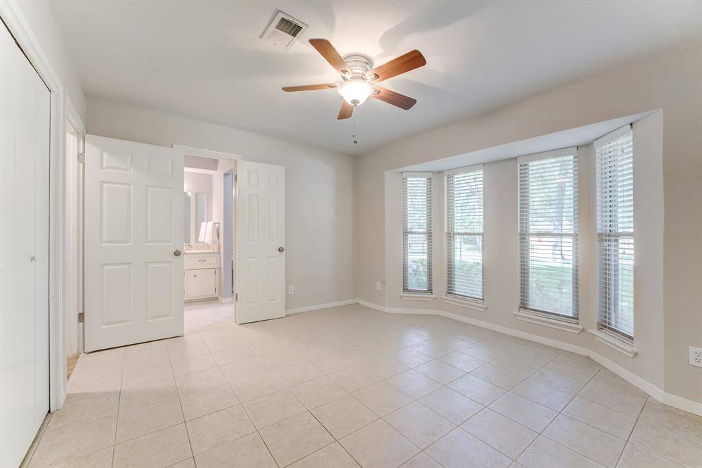 Enjoy the comfort of this spacious secondary bedroom, featuring ample natural light and a beautifully updated ensuite bathroom.