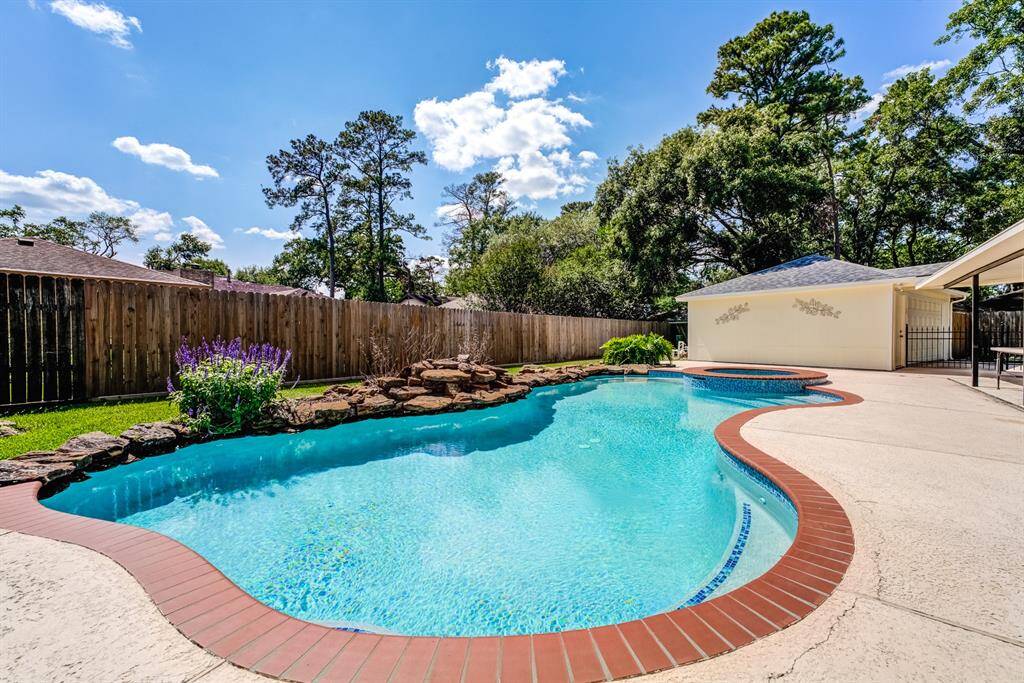 Enjoy a refreshing dip in this sparkling pool, beautifully framed by custom landscaping.
