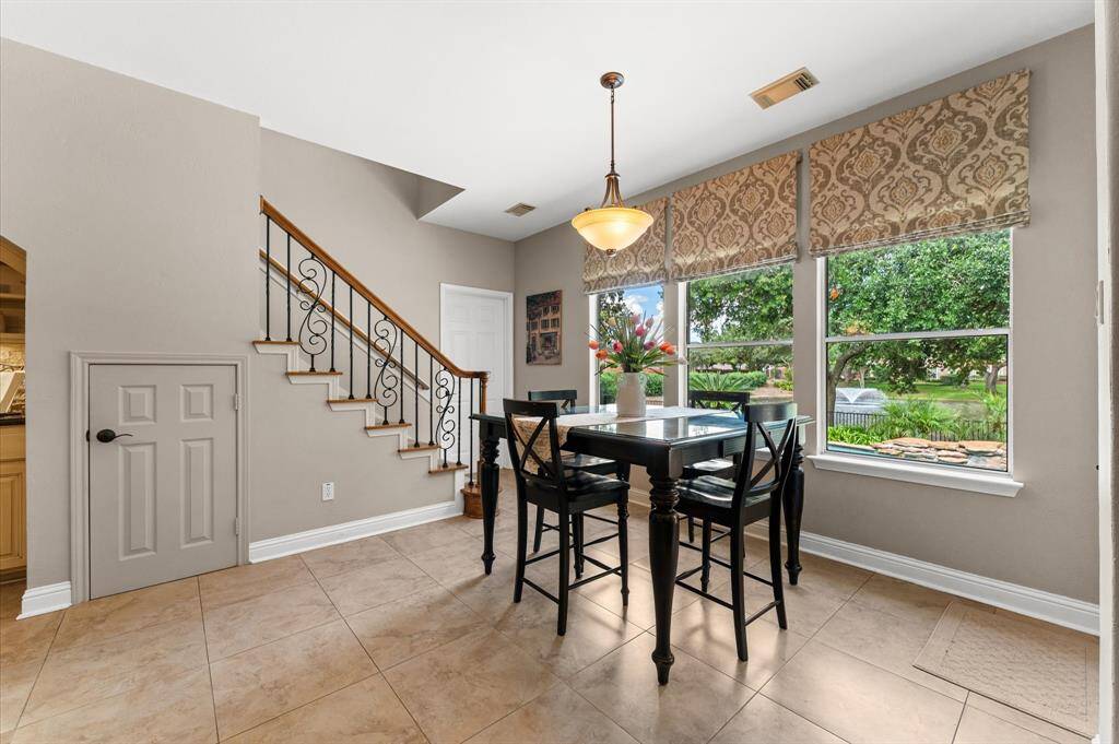 A second staircase off the breakfast leads to the gameroom. Check out the view of the fountain outside of the breakfast room window! The door beyond the staircase leads to the laundry room, a large MUD room, and the garage.