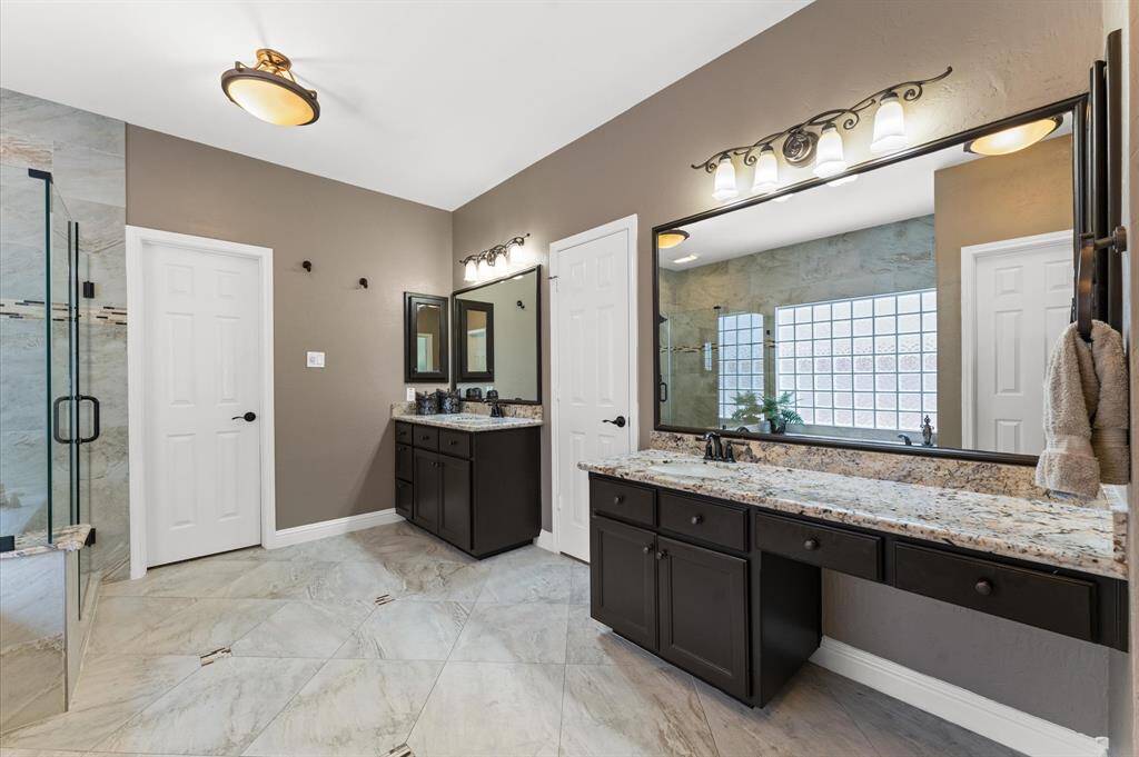Sperate vanities with granite counterops and undermount sinks.