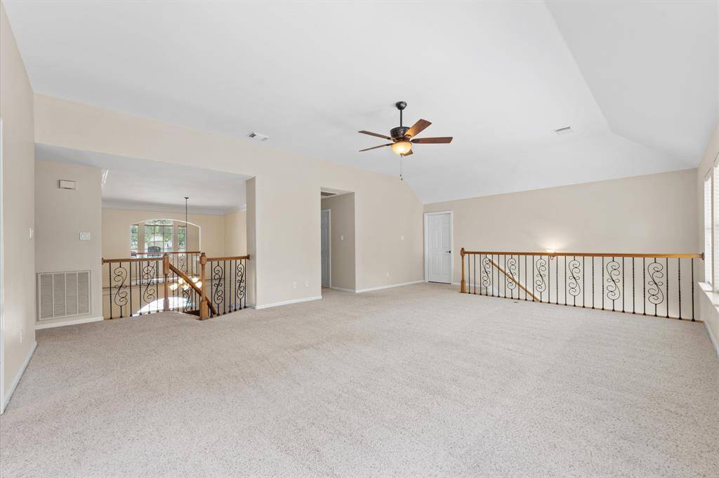 The enormous gameroom. The door off the staircase leads to a huge walk-in attic which is floored for storage.