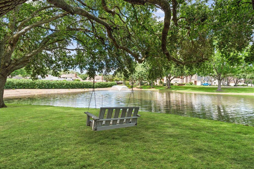 A green space behind the house and mature oaks create a true park like setting.