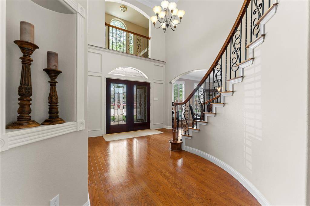 The double doors have elegant etched, lead glass panels. A loft above the front door serves as a study nook and is accessed through one of the bedrooms. The floors are hardwood and can be refinished if desired.