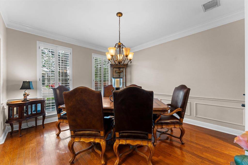 The formal dining room with Plantation shutters and crown molding.