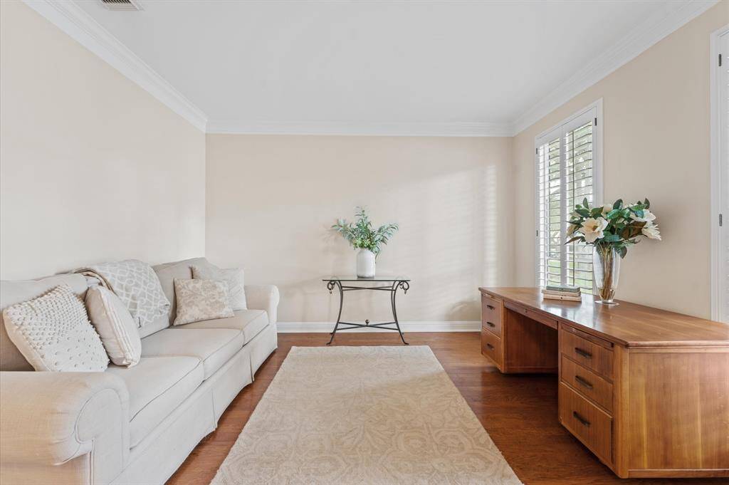 The formal living room also has Plantation Shutters and crown molding.