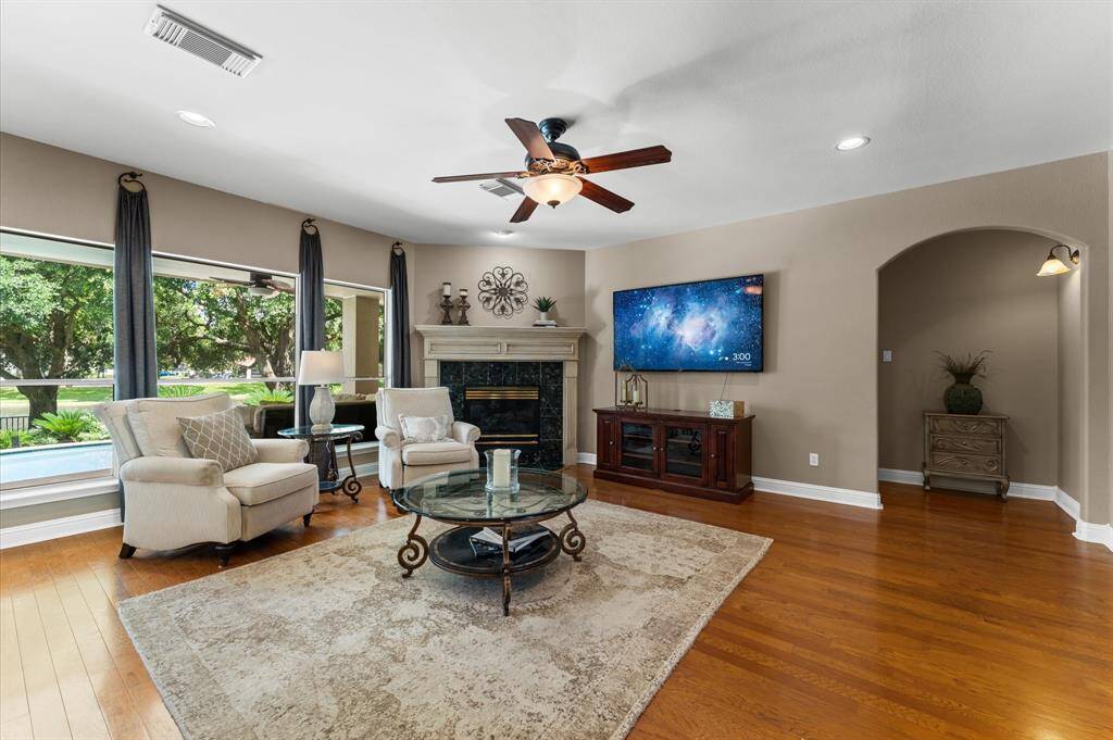The large picture window showcases the magnificent view of the backyard and lake. Hardwood floors run through the family room. The corner fireplace has gas logs.