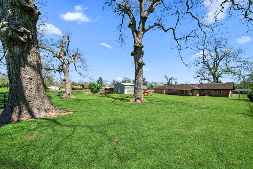 View from the back of the property line. Ample room to room to host a Texas size BBQ. Your home will be the gathering place of family and friends.