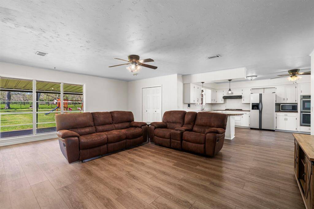 Welcome to your new home! Spacious open floor plan perfect for entertaining. NEW paint, NEW LVP flooring, upgrades throughout. Walls of windows allow natural light to stream and provide panoramic views of the back acreage. This home is gorgeous!