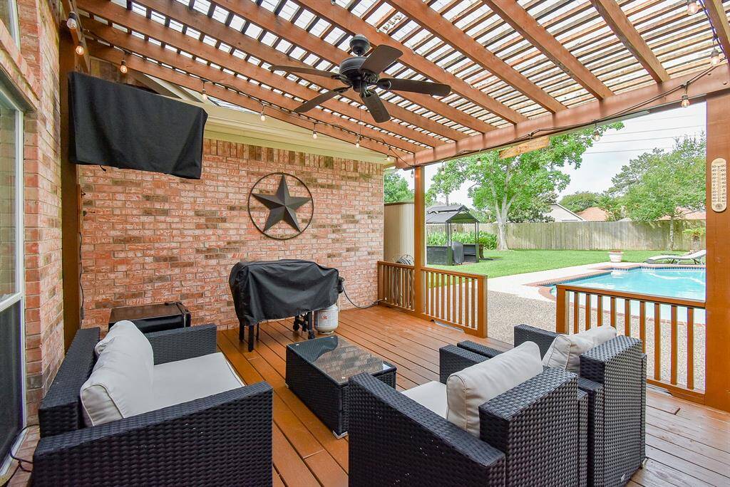 The lush green lawn is beautifully maintained and shaded by mature trees, creating a serene, park-like atmosphere.