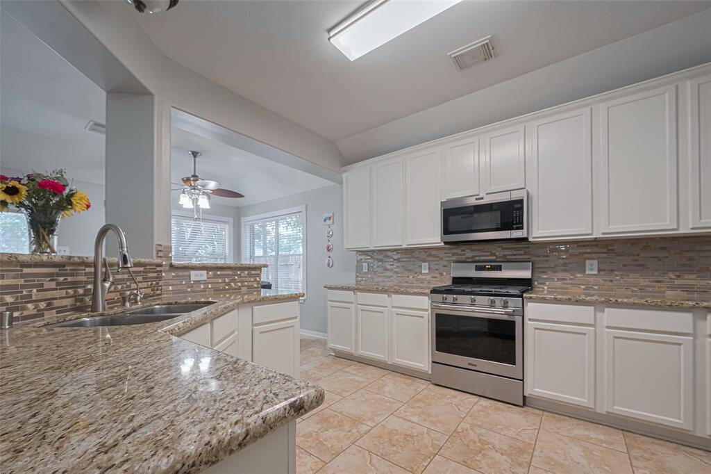 Tons of cabinetry in this beautiful kitchen with granite countertops and stainless steel appliances