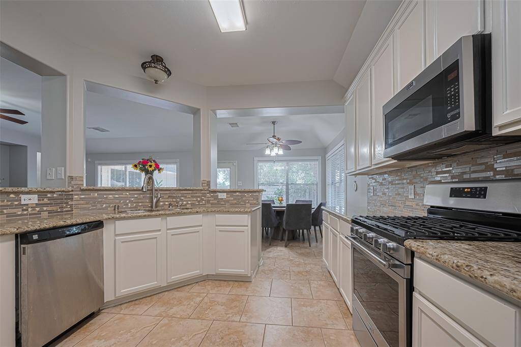 Additional view of the kitchen open to the family and breakfast room