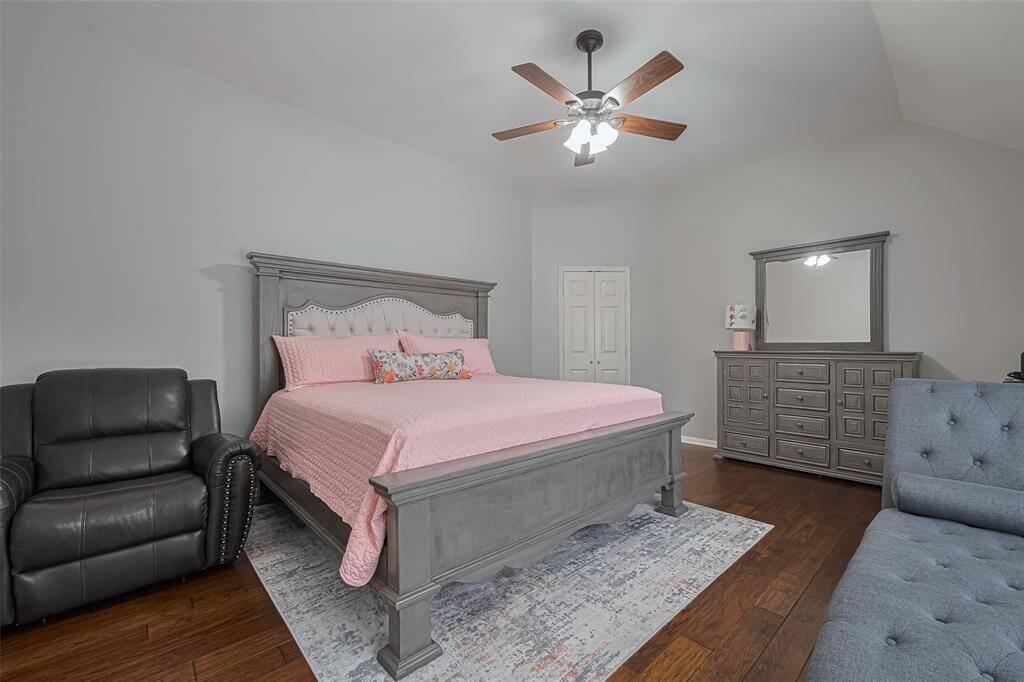 Primary bedroom featuring high ceilings and large windows