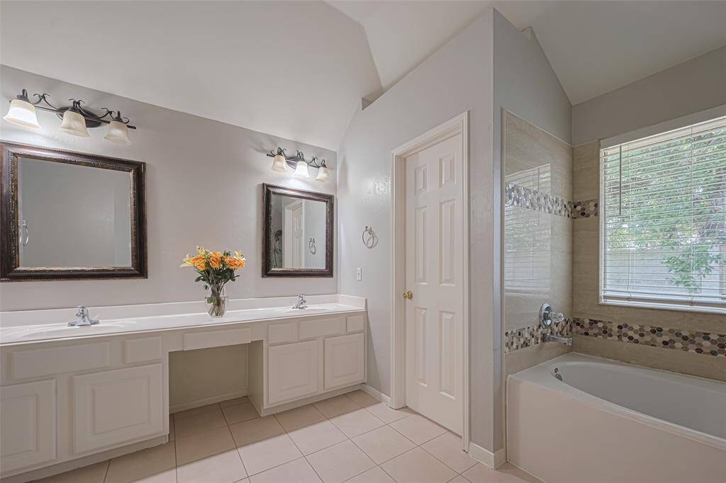 En-suite primary bath with vanity, double sinks, walk-in shower and separate tub. Additionally, 2 huge walk-in closets (not pictured)