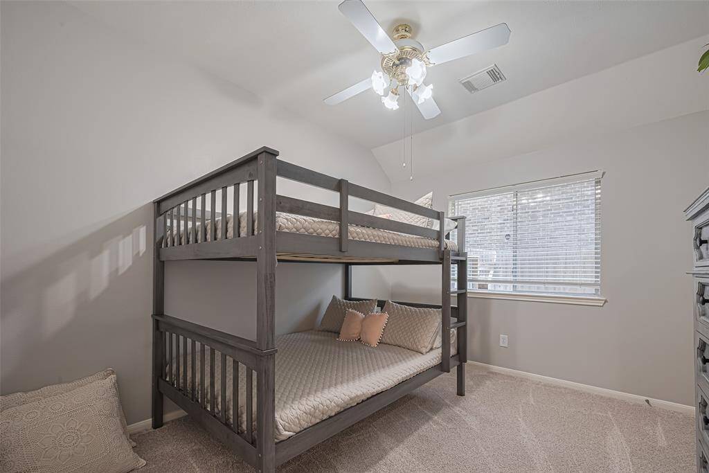 Third bedroom with tons of natural light and beautiful carpet.