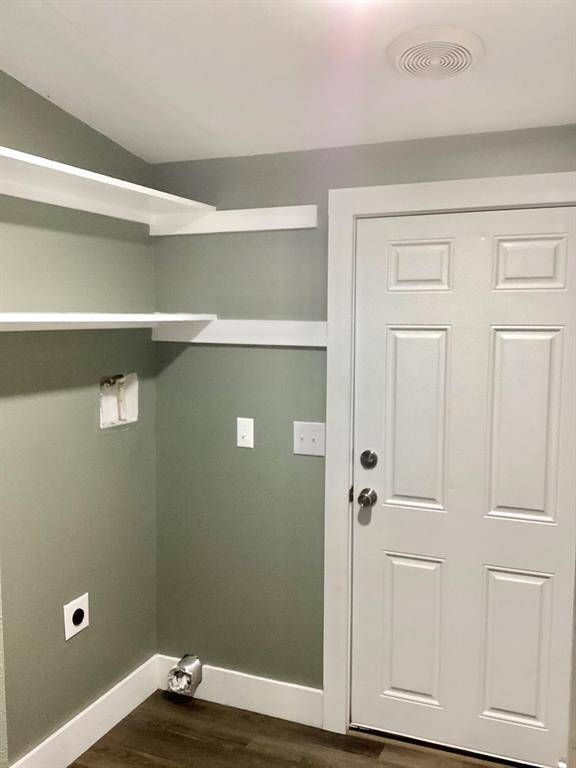 Laundry room with hookups for a washer and dryer. Door that leading outside