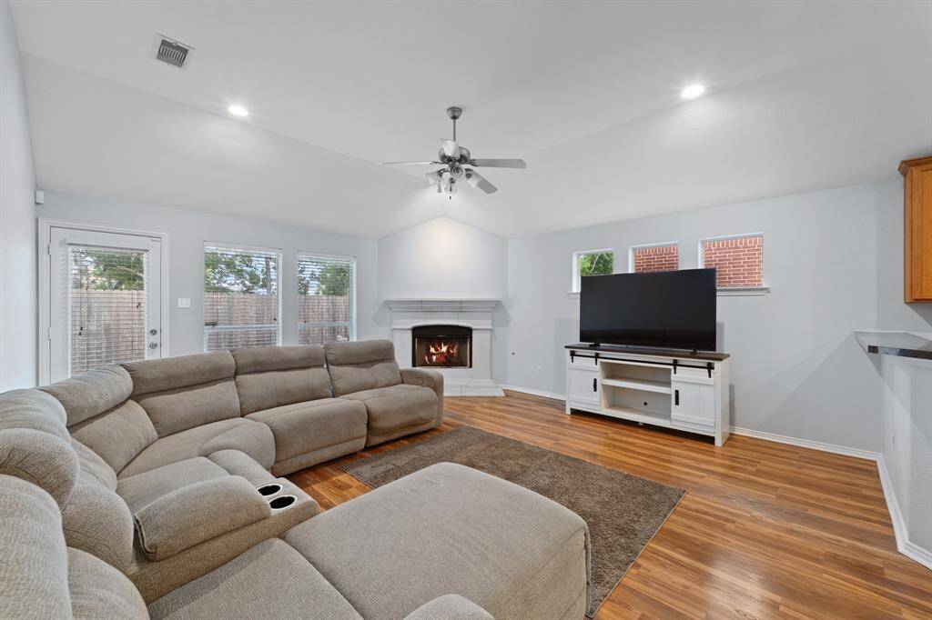 Nice sized family room with a cozy fireplace.