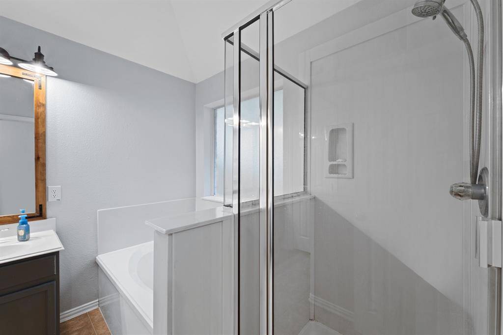 Primary bathroom tub and shower.