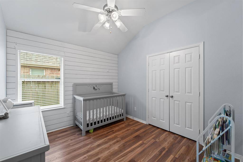 Secondary bedroom #2 has an added feature wood paneling on the wall.