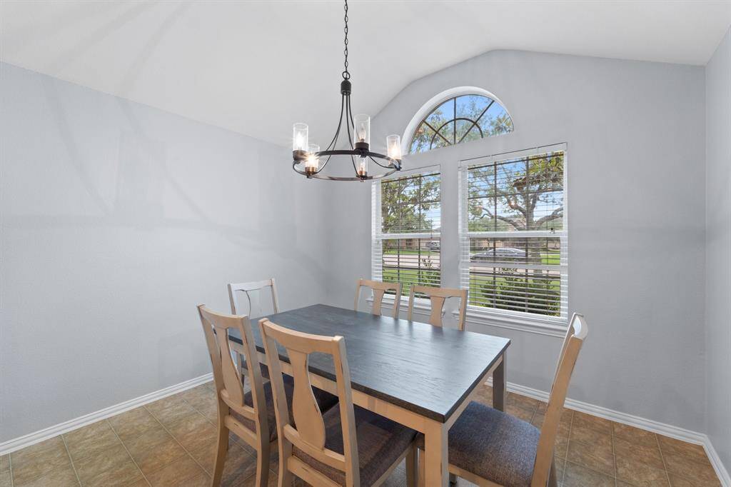 Dining room with raised ceilings and nice big windows.