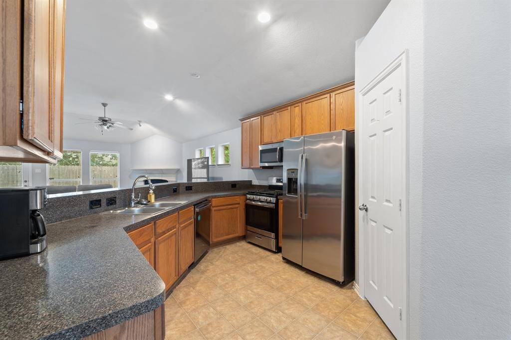 Kitchen is equipped with a good amount of cabinet storage and counterspace.