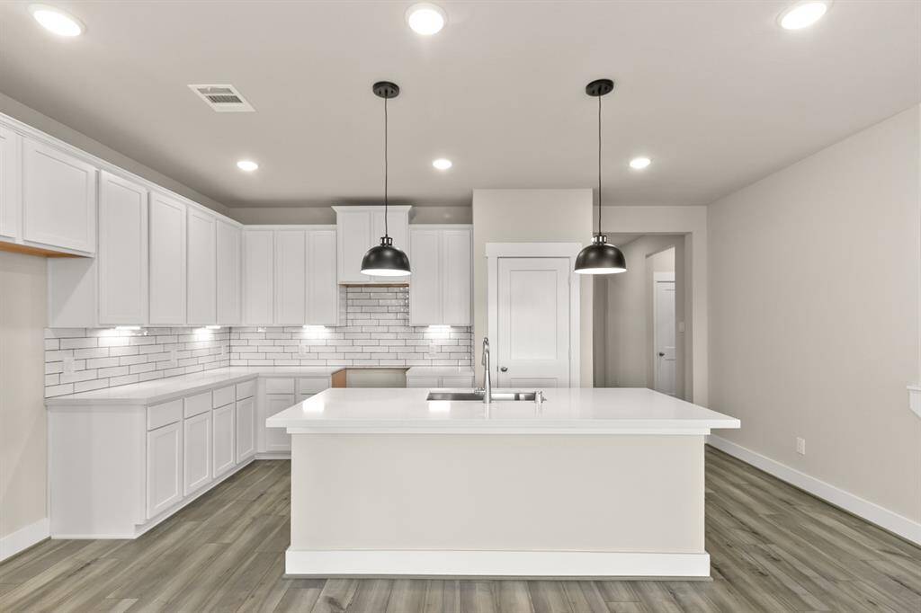 A huge kitchen island that will be the envy of all your friends at your next happy hour. Welcome home!