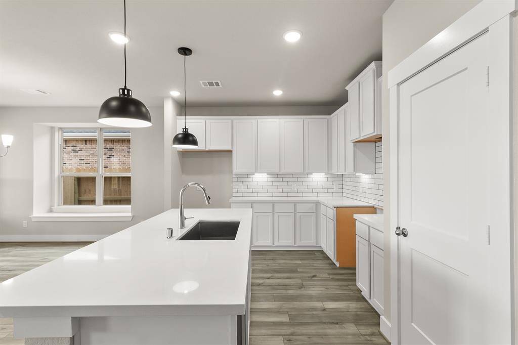 This beautiful brand-new kitchen boasts stunning cabinetry that stretches to the ceiling, offering both style and ample storage for all your culinary treasures.