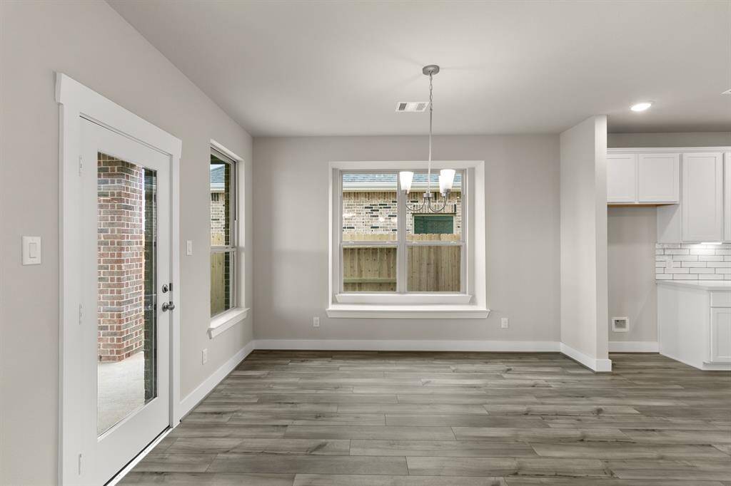 You'll love how the open layout seamlessly connects to the kitchen, making it easy to serve up your favorite dishes while still being part of the conversation.